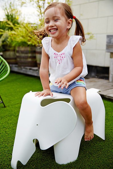 Eames Elephant brand Vitra in the garden with a smiling baby