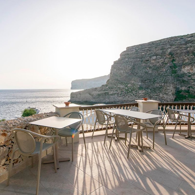     Pedrali Reminiscent of gray chairs and tables in a terrace restaurant with panoramic sea views. 